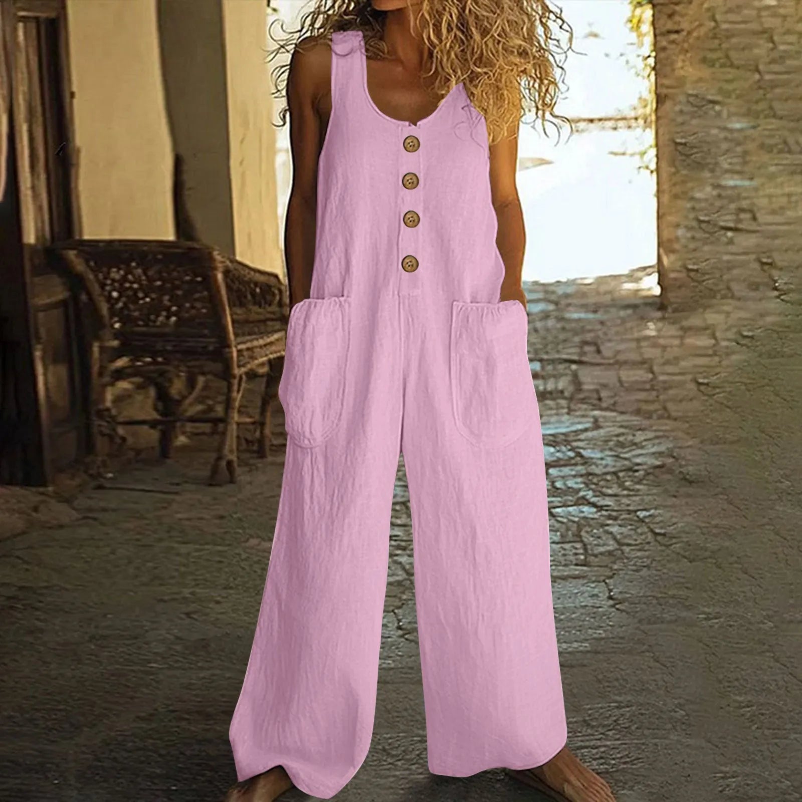 Sleeveless wide leg cotton jumpsuit in peacock green colour showing loose fit and pocket detail.