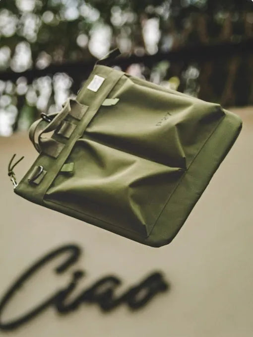 Canvas crossbody messenger bag in military green colour with shoulder strap and hard handle