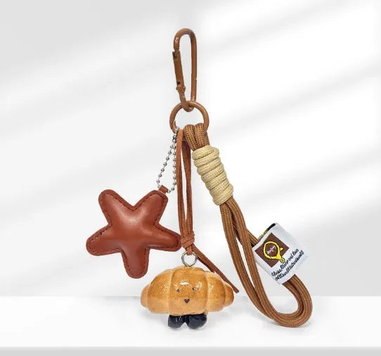 Handbag pendant charm with handmade soda bread design patterns including brown star, croissant, and bagel