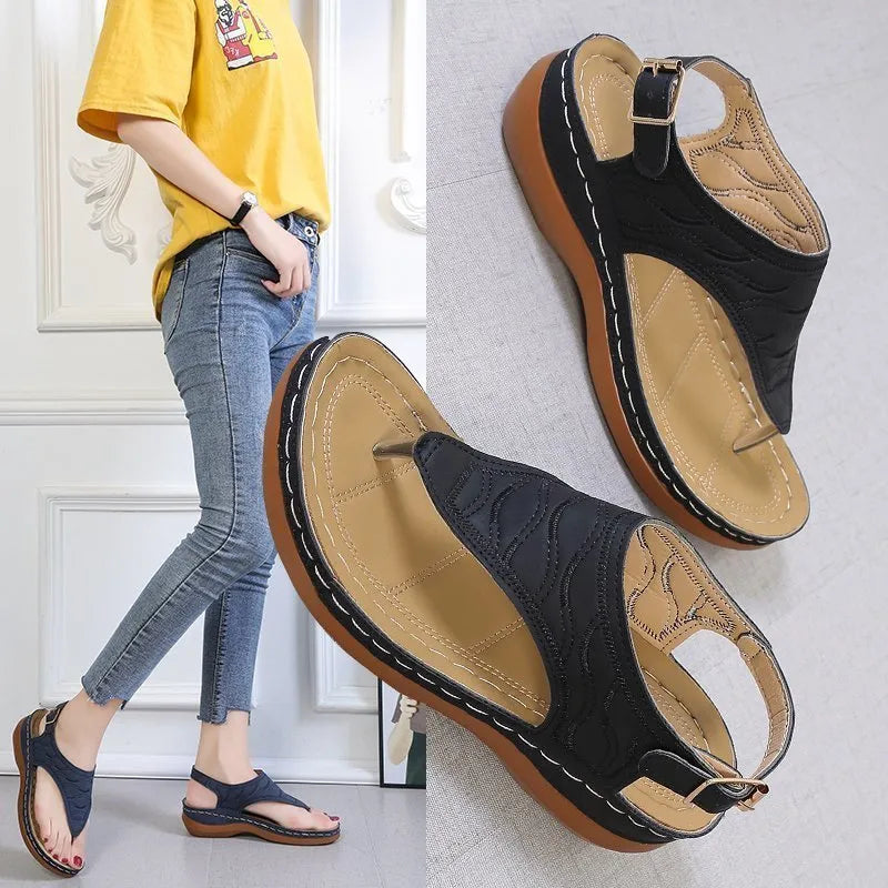 Women's casual wedge heel flip flop sandals with an adjustable buckle strap in black.