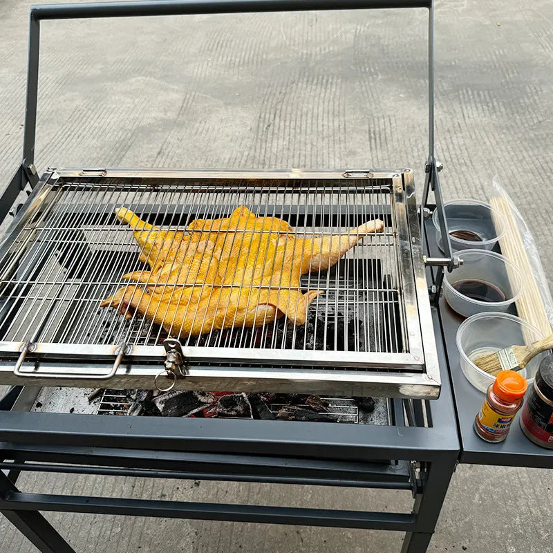 Large foldable charcoal barbecue grill stove shown in outdoor courtyard setting