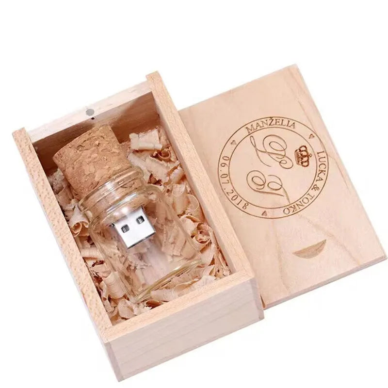 Wooden-capped transparent glass bottle USB flash drive on a wooden surface.