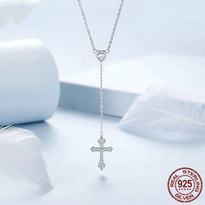 Simple sterling silver V-neck cross pendant on an O-ring chain necklace.