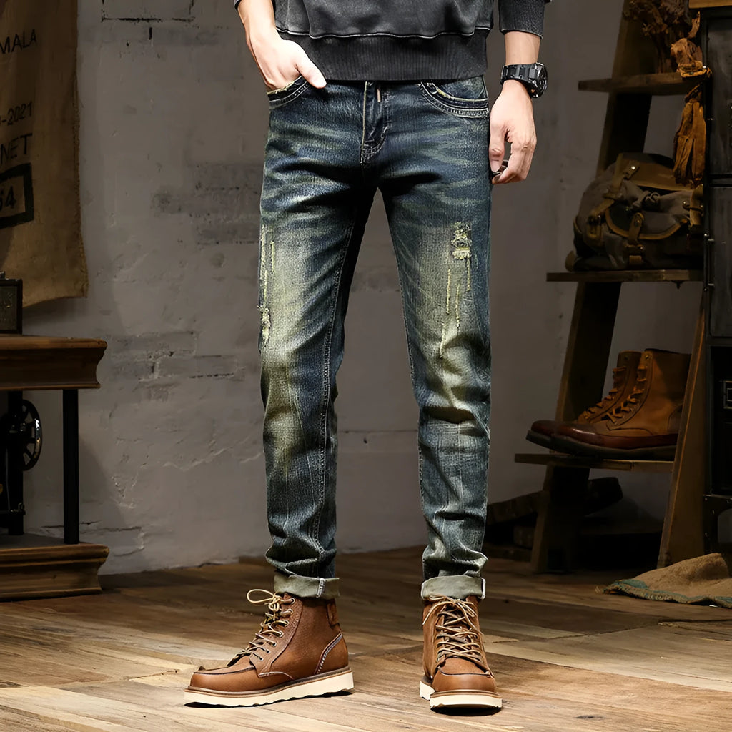 Men's skinny fit retro blue jeans with a zip fly on a plain background