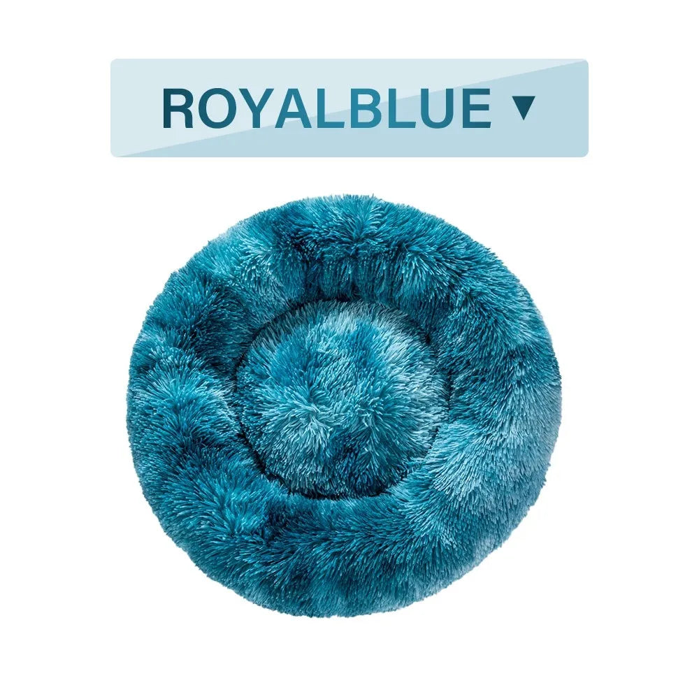 Fluffy donut-shaped pet bed in long plush fabric, shown in a light grey colour.