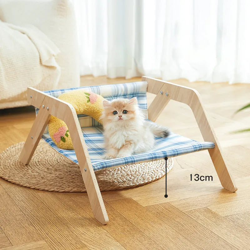 Wooden elevated cat bed with blue cloth cushion for indoor cats