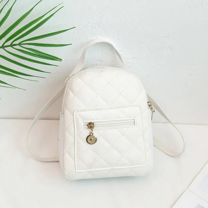 Girls' hard-shell vertical square backpack with embroidery in pink, showing front view and soft carry handle.