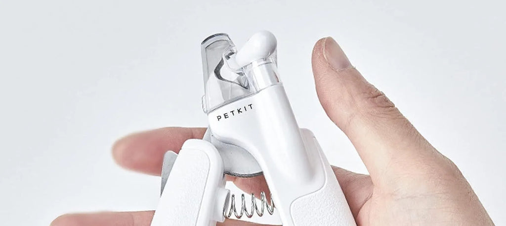 White pet nail clippers with LED light, transparent anti-splash baffle, and triangular steel blades for cats and dogs