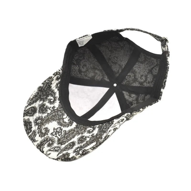 Blue polyester baseball cap with a white paisley pattern, showing the dome crown style.