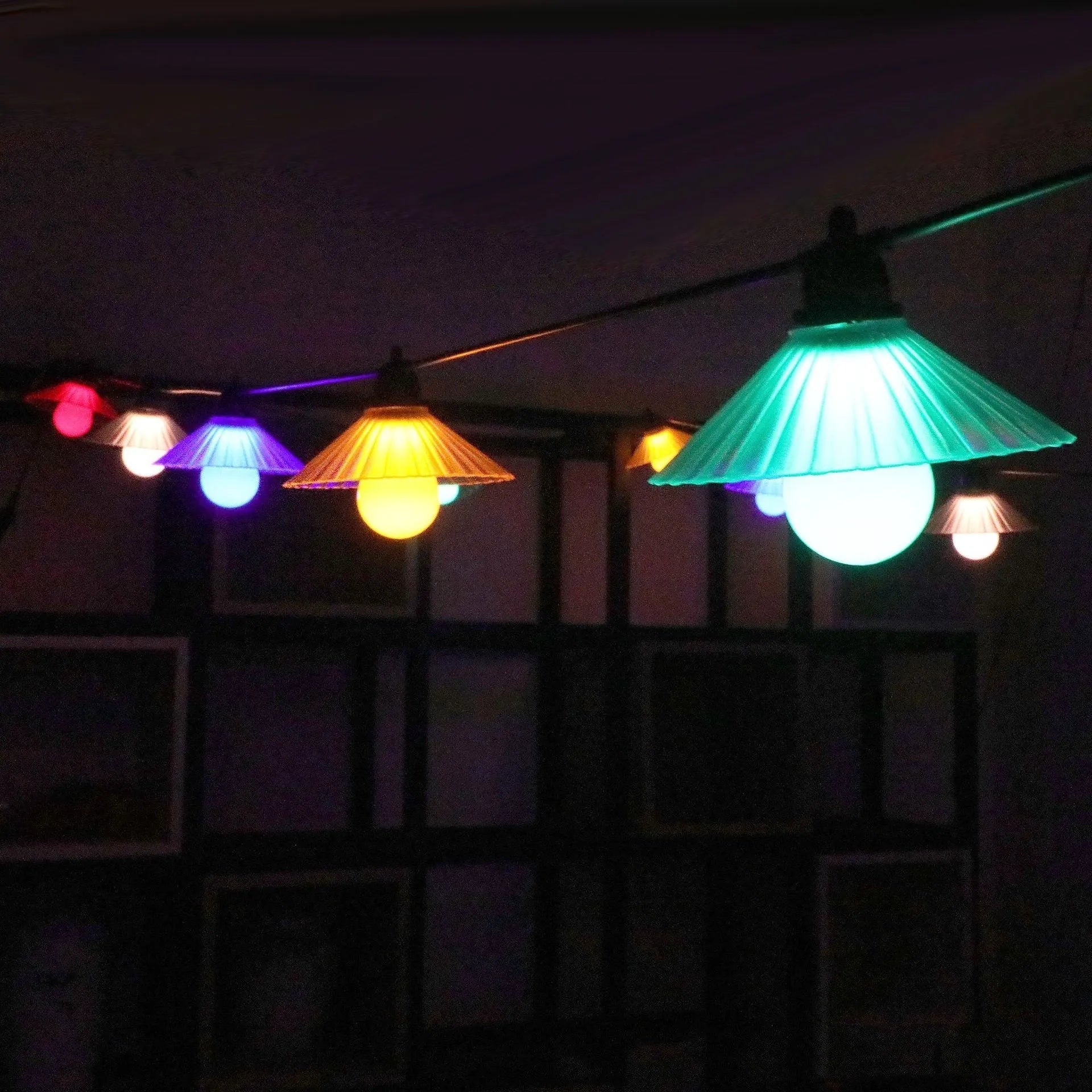 Outdoor LED string lights with flower-shaped globes in various colours including warm white