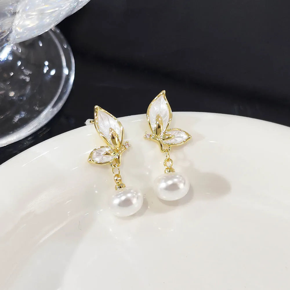 Pair of simple style butterfly earrings for women with electroplated copper construction.