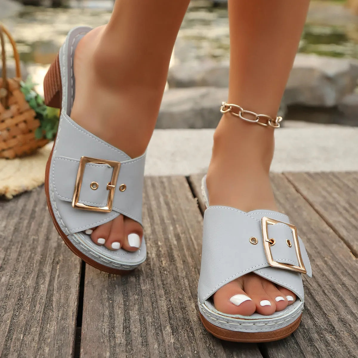 Women's black retro style slippers with a chunky heel and silver metal buckle on a rubber sole.