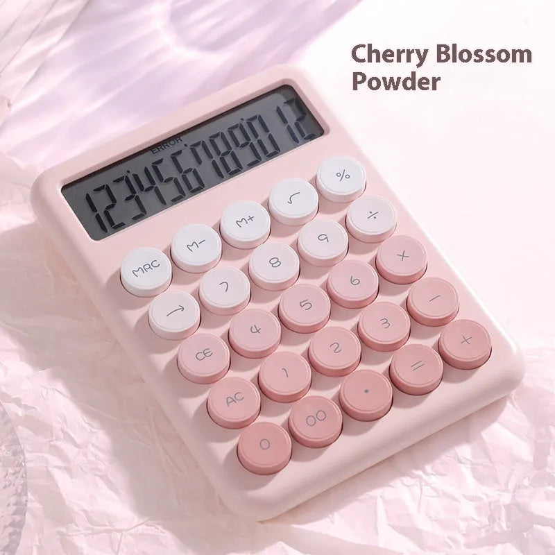 Dopamine gradient colour desk calculator in violet, pink, blue, and green options on a desk