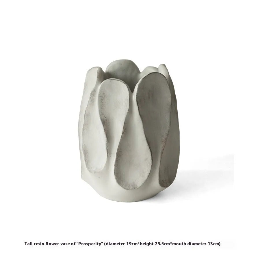Handmade irregular shaped ceramic vase in natural glaze on a wooden surface.