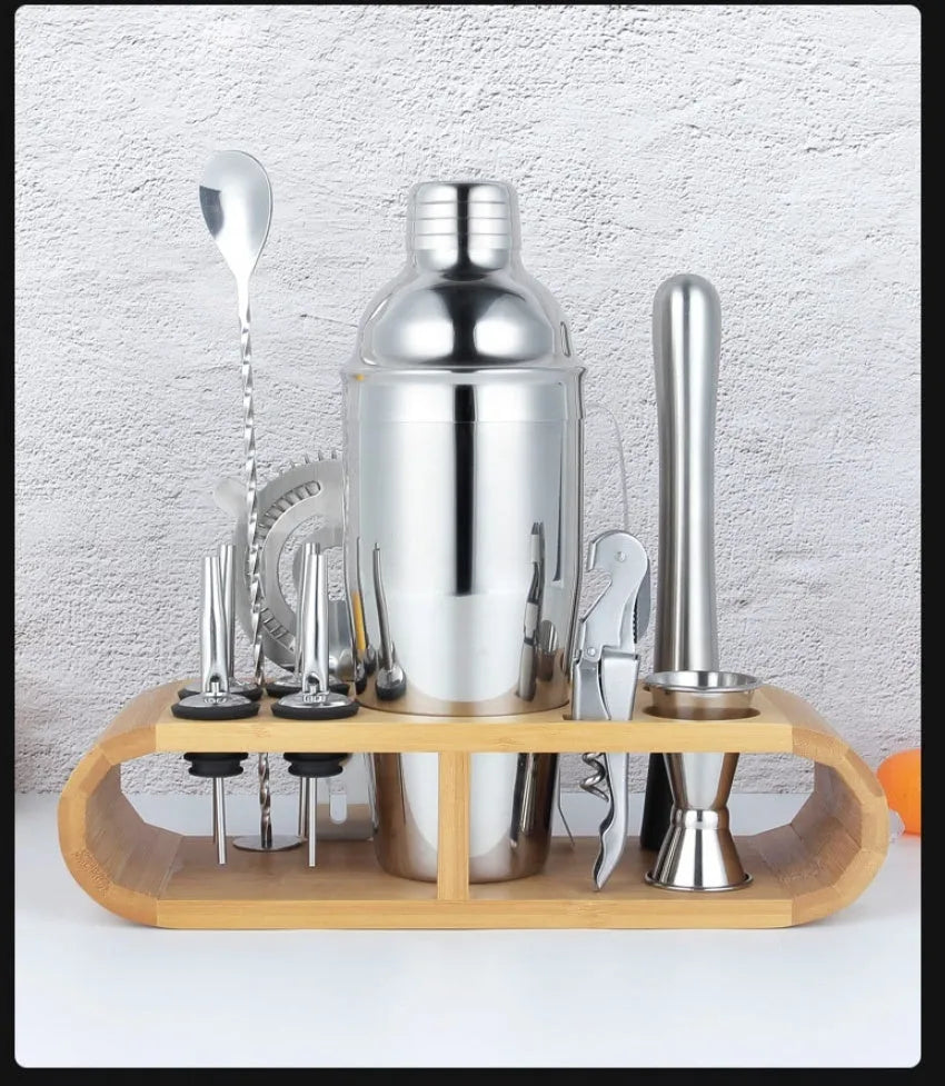 23-piece European style stainless steel cocktail set with shaker, strainer, and bar tools on a table.