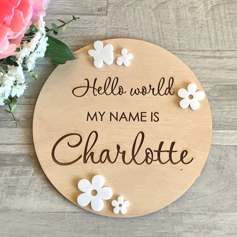 Square 15cm wooden baby name plaque with birth details displayed, shown in three style options.