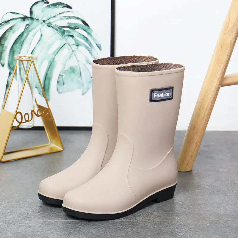 Women's mid-calf PVC rain boot in black, shown with a low heel and optional wool lining.
