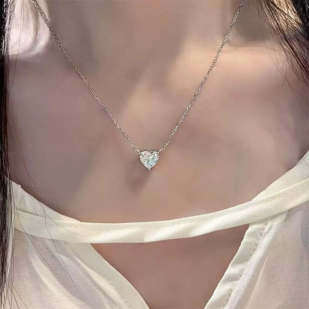 Silver-coloured copper heart pendant necklace on a chain, simple refined graceful design