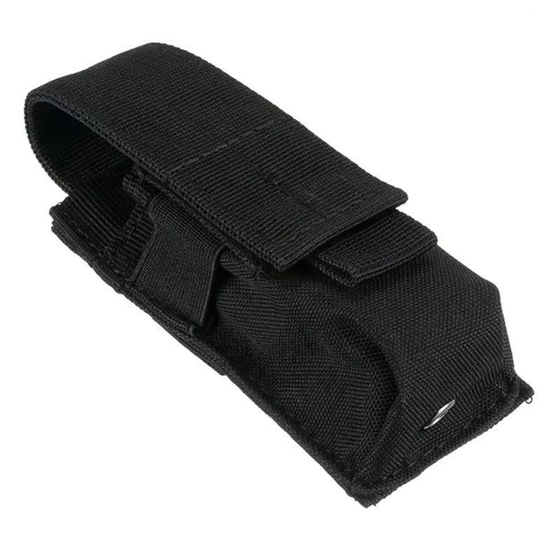 Black tactical molle waist bag for pistol cartridges or a small flashlight, showing elastic cord buckle.