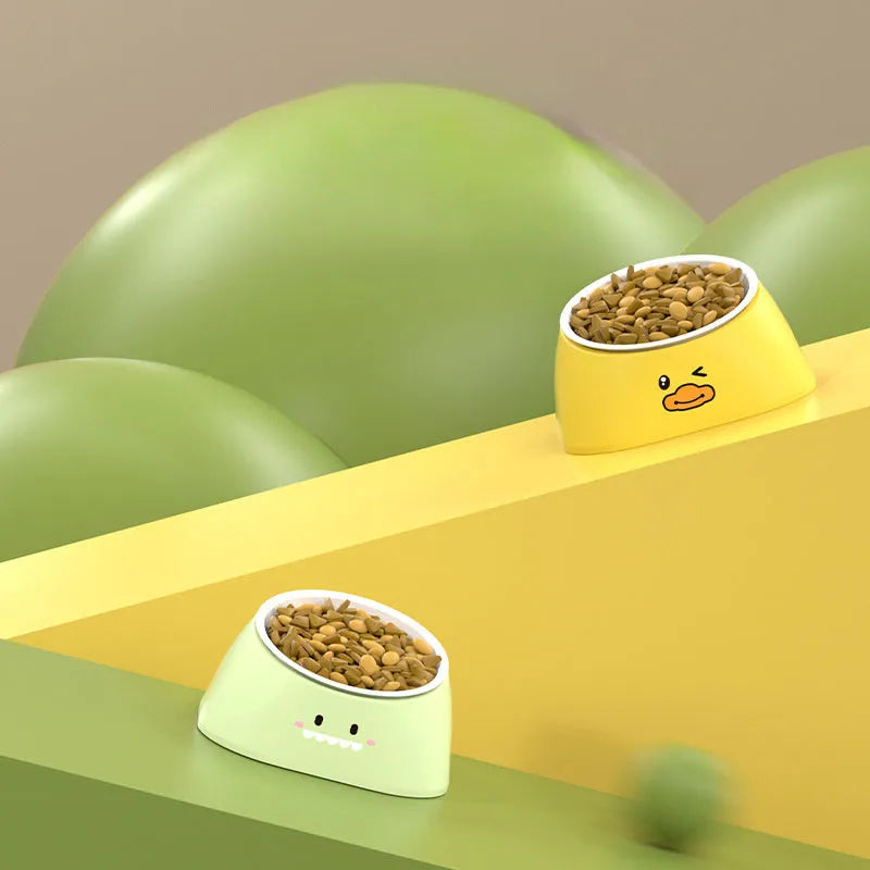 Green tilted stainless steel cat bowl at a 15-degree angle on a table.