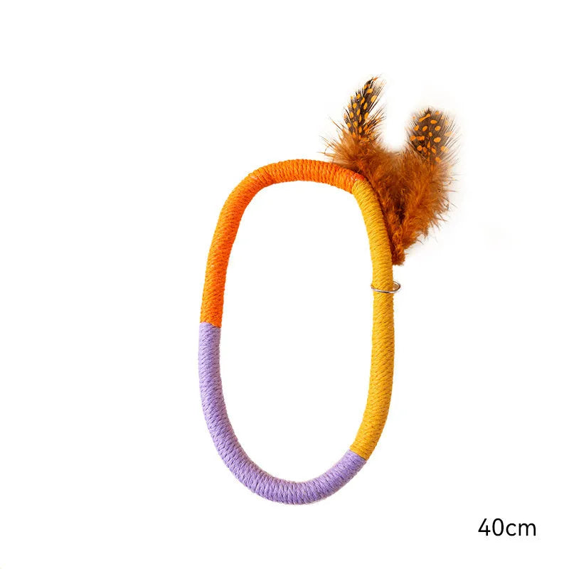 Green circular cotton rope cat toy with feathers and catnip for chewing and kicking play