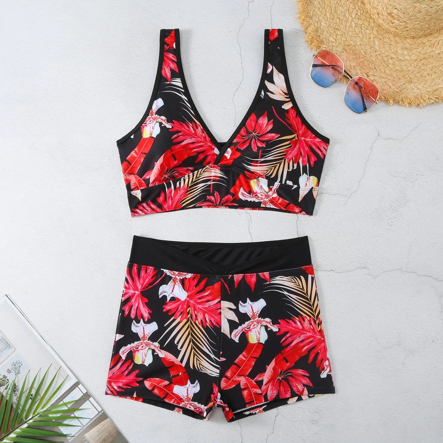 Women's two-piece swimsuit set with sleeveless top and printed boxer-style bottoms in a multi-colour pattern.
