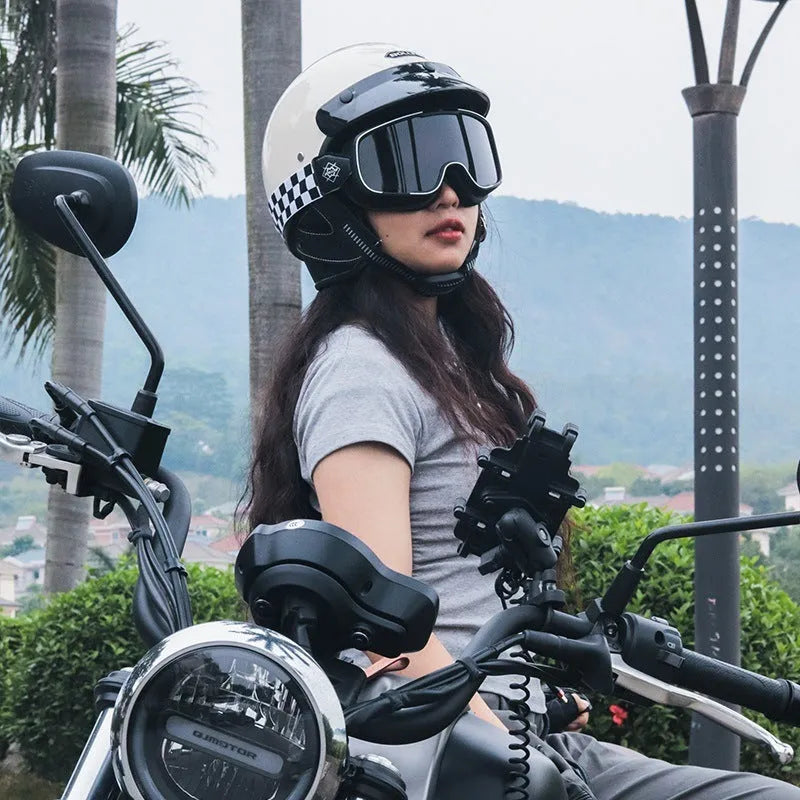 Retro full-face motorcycle helmet in cement grey on a stand