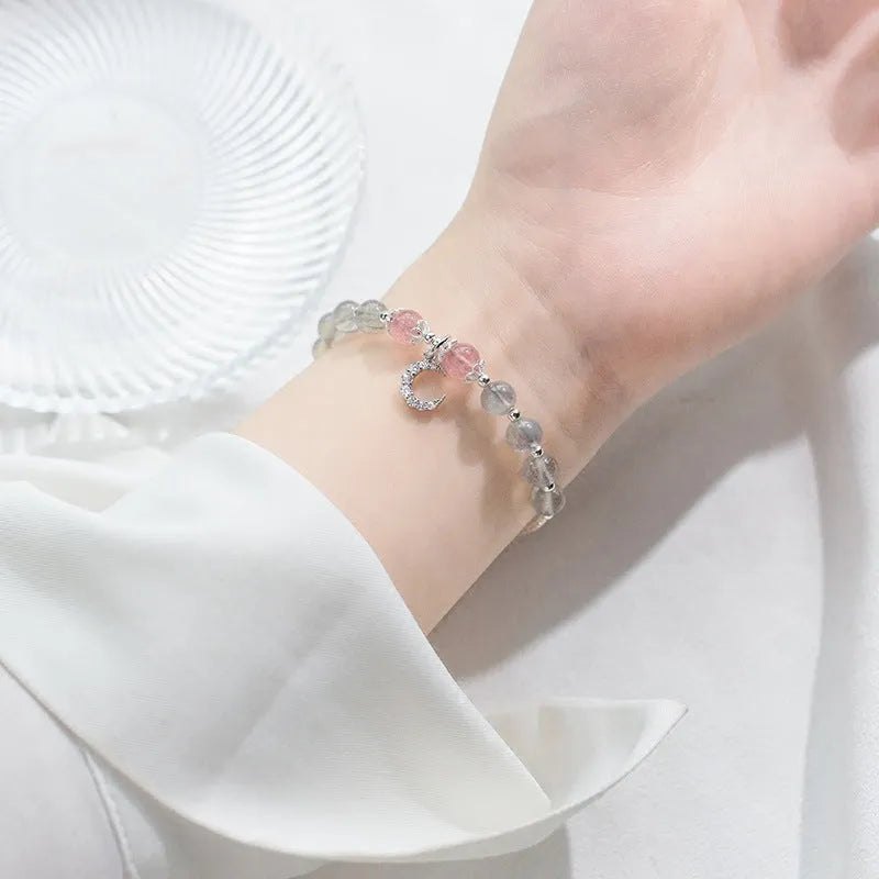 Natural moonstone handmade bracelet with crescent moon charm on wrist showing adjustable clasp