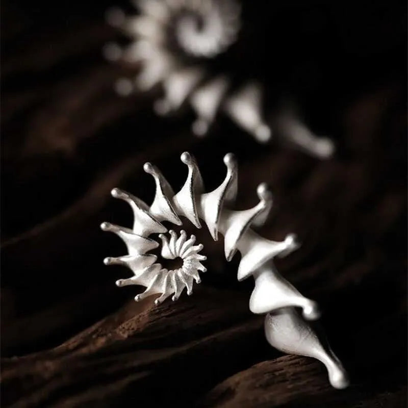 A pair of conch-shaped stud earrings with a three-dimensional matte finish in an irregular simple style.