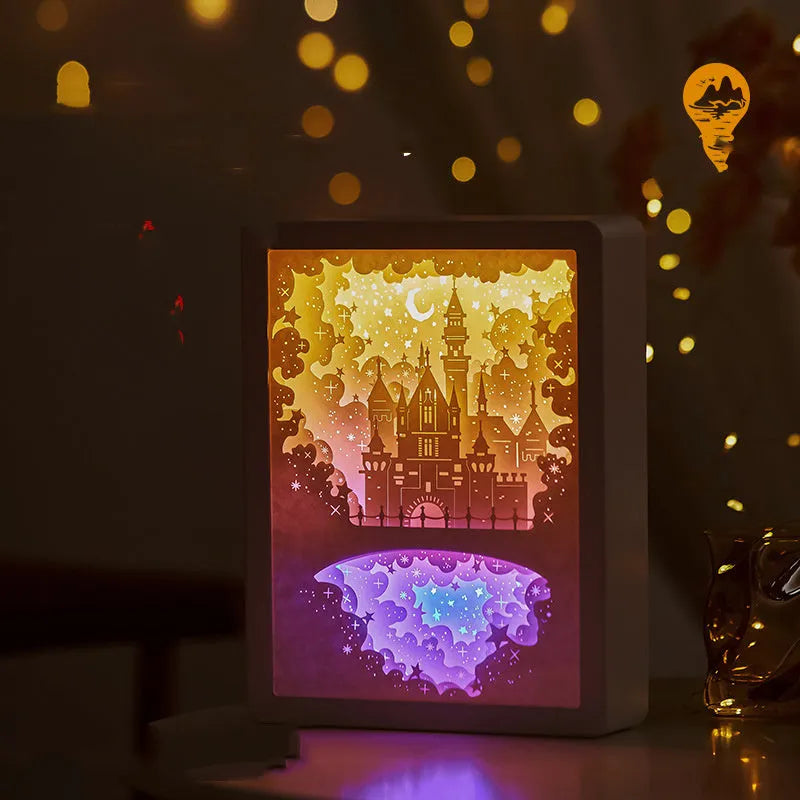 Modern bedside USB night light with paper carving design and remote control on a table.