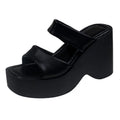 Women's black platform wedge slippers with a square toe design on a white background.