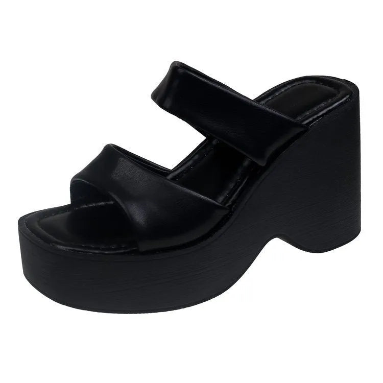 Women's black platform wedge slippers with a square toe design on a white background.