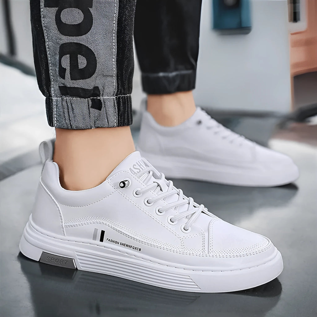 Men's white and black low-top skate shoes with an elastic band and round toe on a rubber sole.
