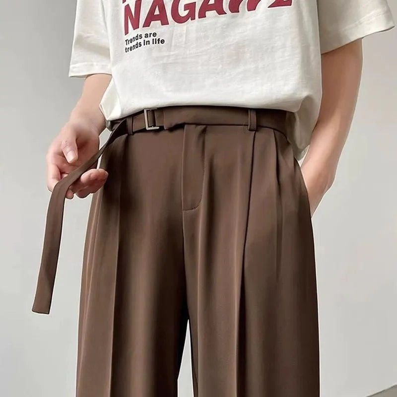 Black wide leg straight trousers with a loose casual fit on a hanger.