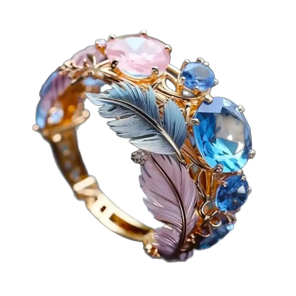 Gold colour embossed feather brass ring with zircon inlay detail showing textured surface