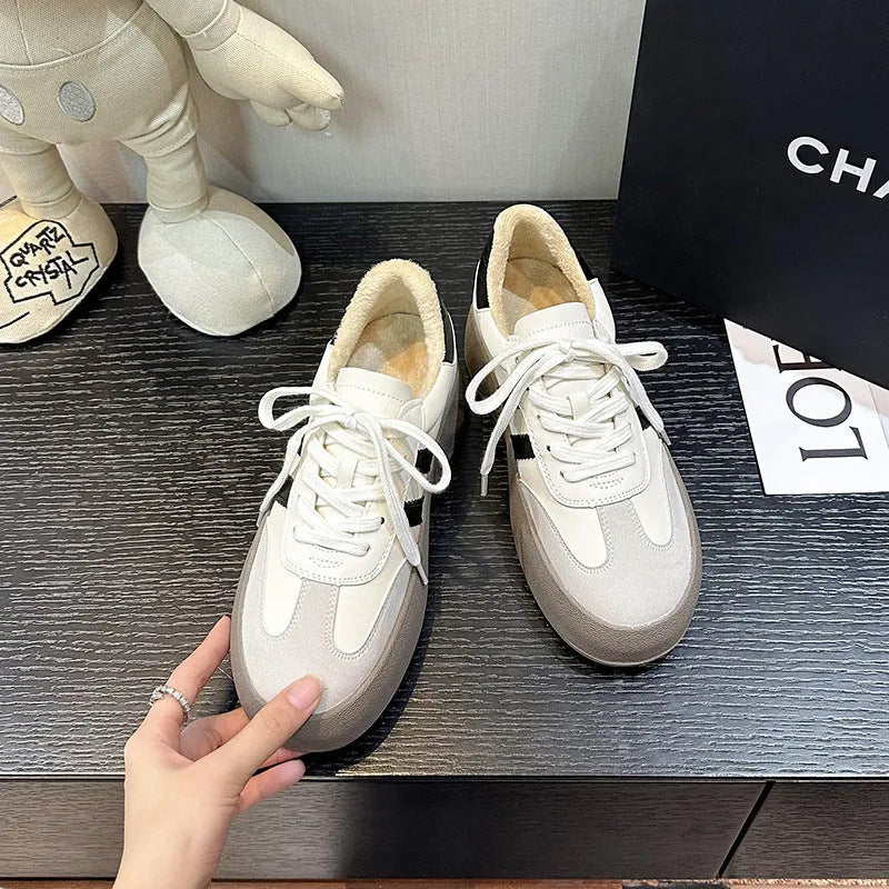 Women's beige distressed leather vintage lace-up sneakers with round toe and rubber sole on a white background.