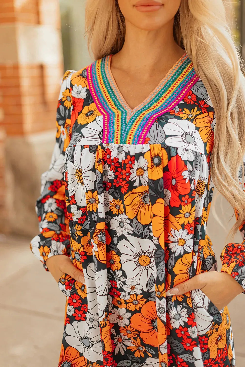 Orange floral print mini dress with striped and lace long sleeves and a V neckline.