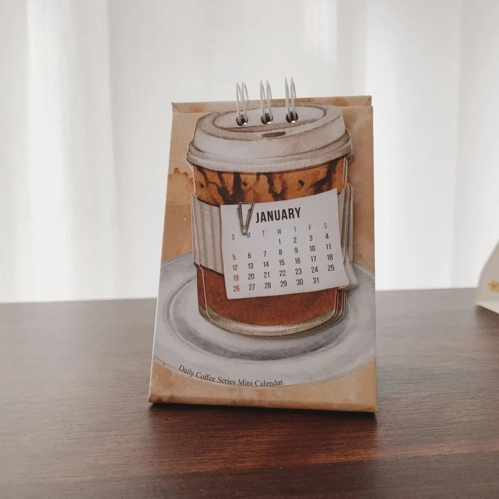 Mini 2025 desk calendar in a simple modern design on a wooden desk
