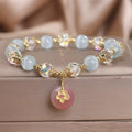 Chinese style sky blue opal peace buckle pendant bracelet for women on a flat surface