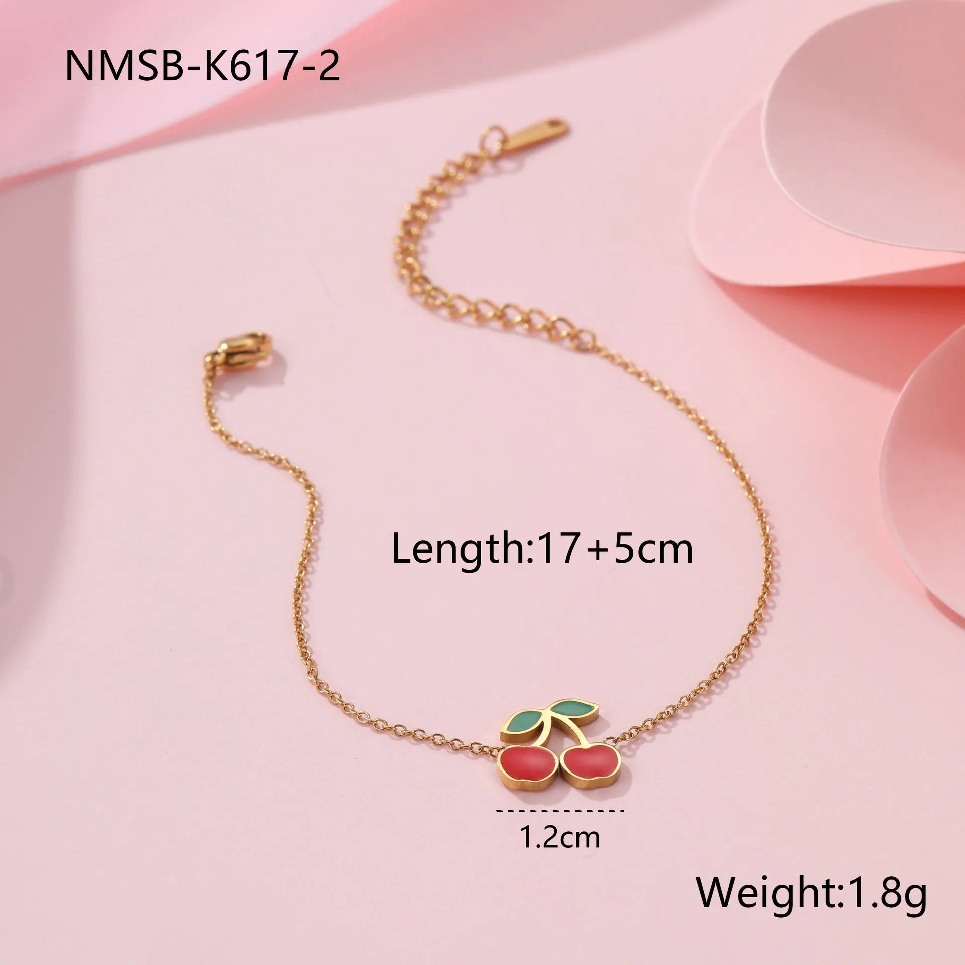 Cherry-themed jewellery set showing stainless steel necklace, bracelet, earrings, and ring with 18K gold plating.