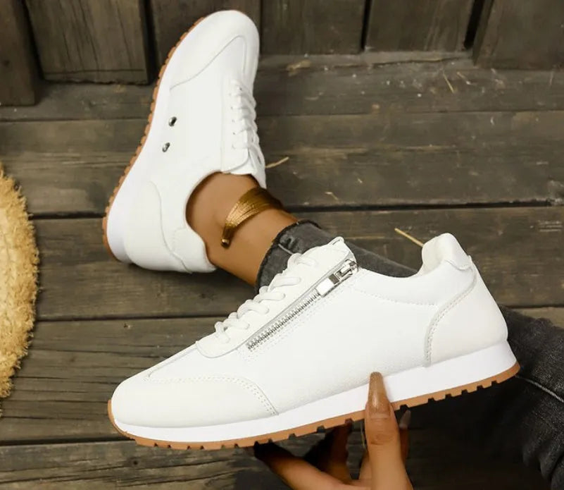 Women's flat-heeled casual shoes in champagne, grey, and white colours with artificial PU upper.