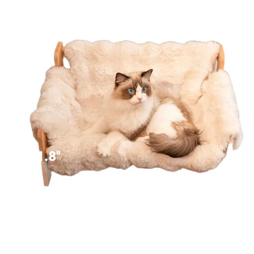 Beige cotton cat bed with wooden sofa-style frame and removable washable cover