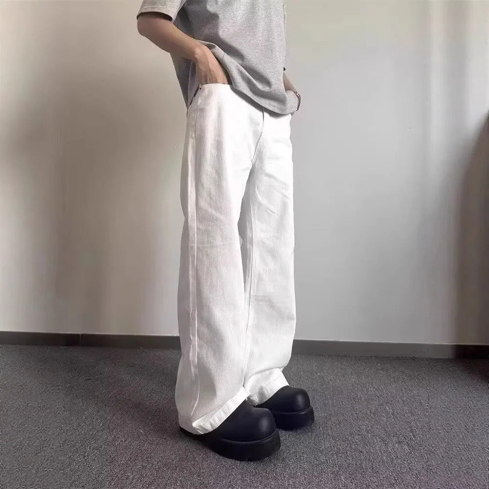 Men's white straight leg wide fit cotton denim jeans on a hanger