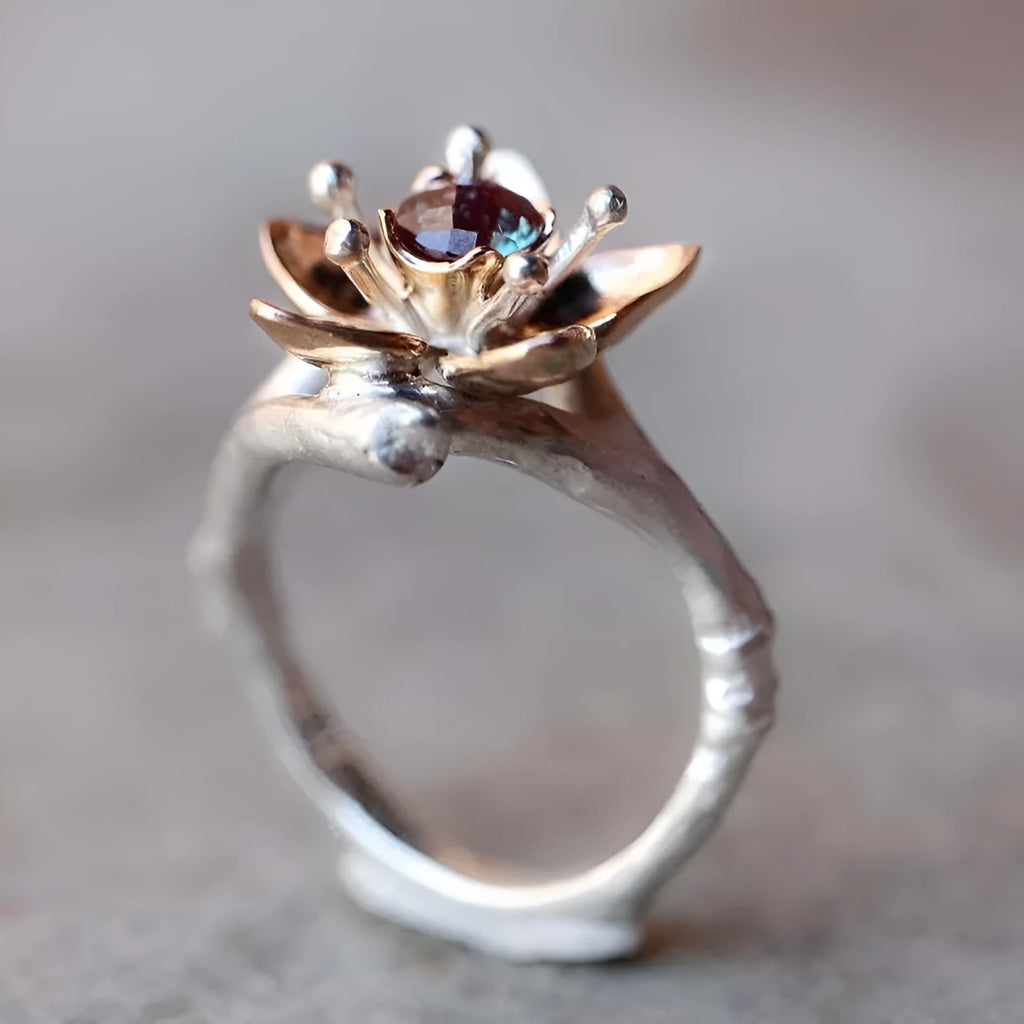 Silver two-tone floral geometric women's alloy ring shown on a finger.