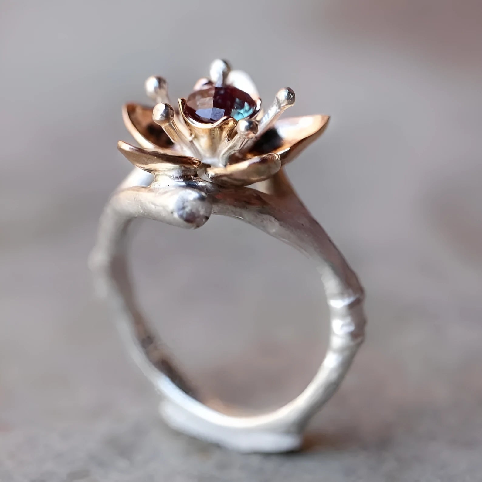 Silver two-tone floral geometric women's alloy ring shown on a finger.