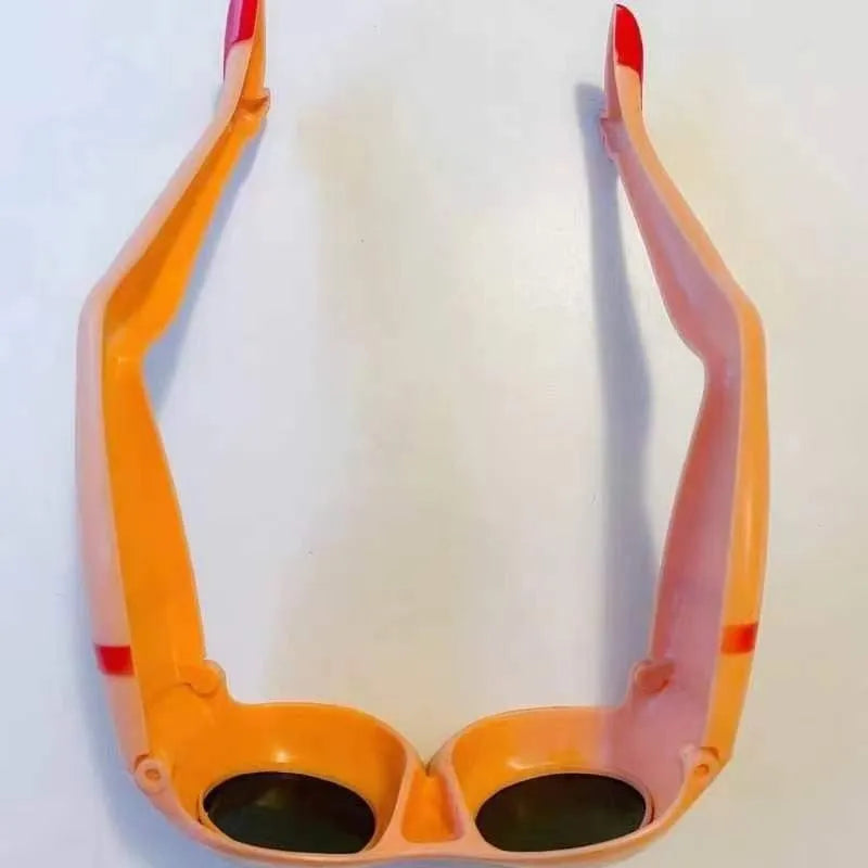 Orange plastic sunglasses with a personality leg and hip design.