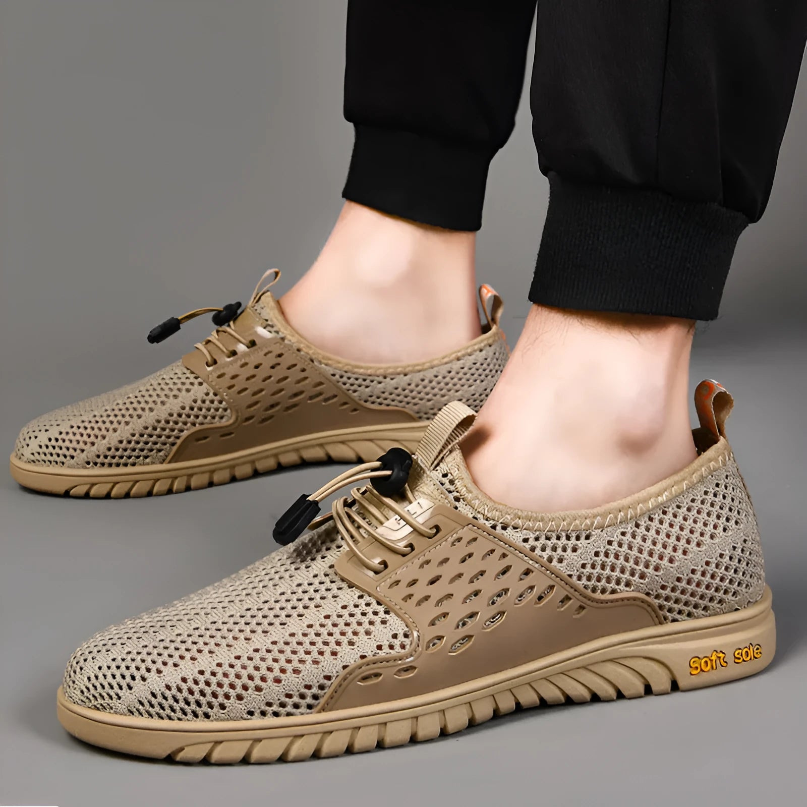 Men's black breathable mesh casual shoes with an elastic band closure and rubber sole