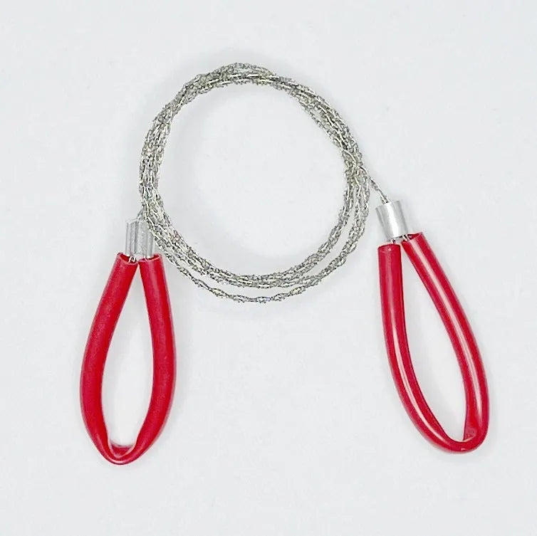 German stainless steel survival wire saw coiled up, showing its four-strand construction and compact size.