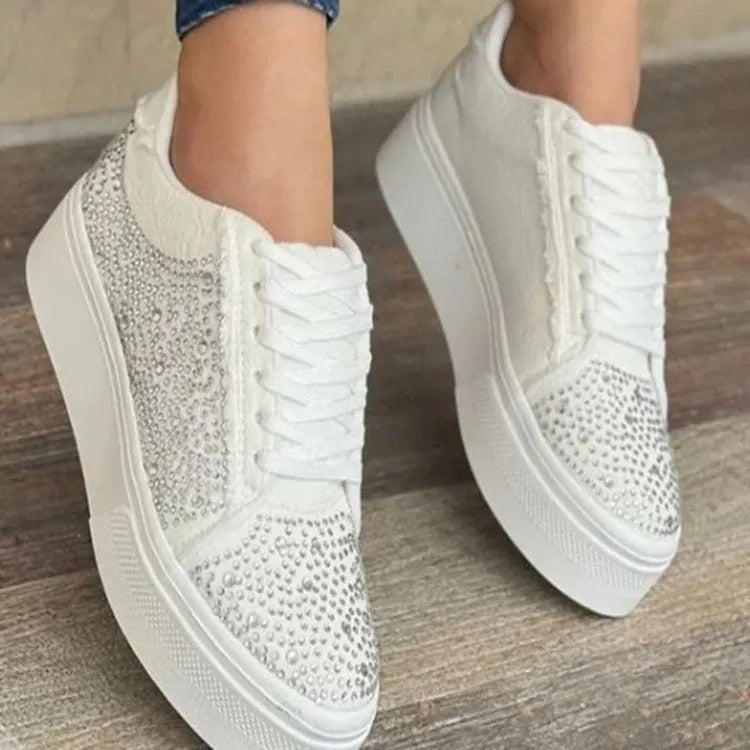Women's black casual flat shoes with thick rubber sole, lace-up front, and rhinestone decoration.