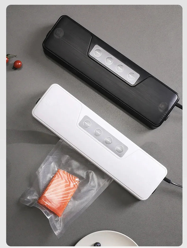 Small black automatic vacuum sealer machine on a kitchen countertop